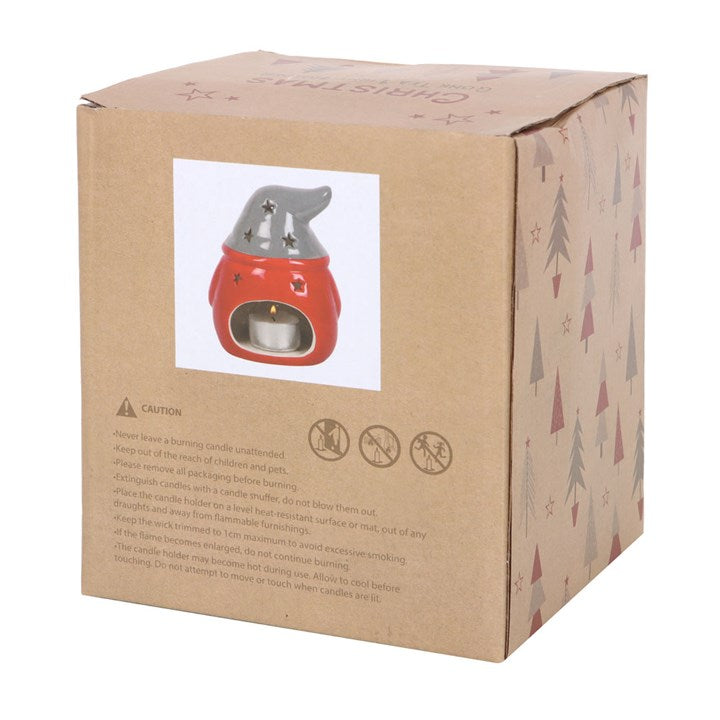 Cardboard box with a small red candle warmer on a white background