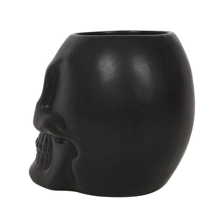Black skull-shaped planter on a white background