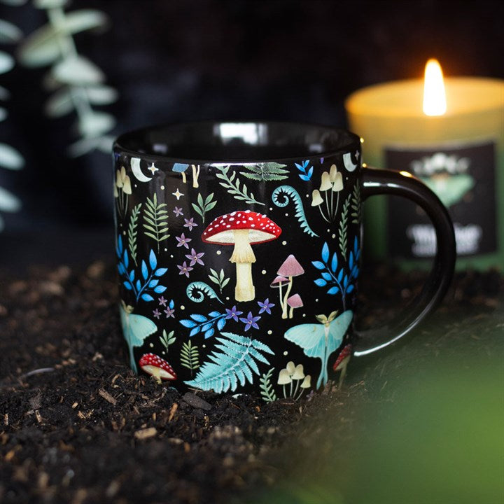 Black mug with colorful forest pattern on a dark background