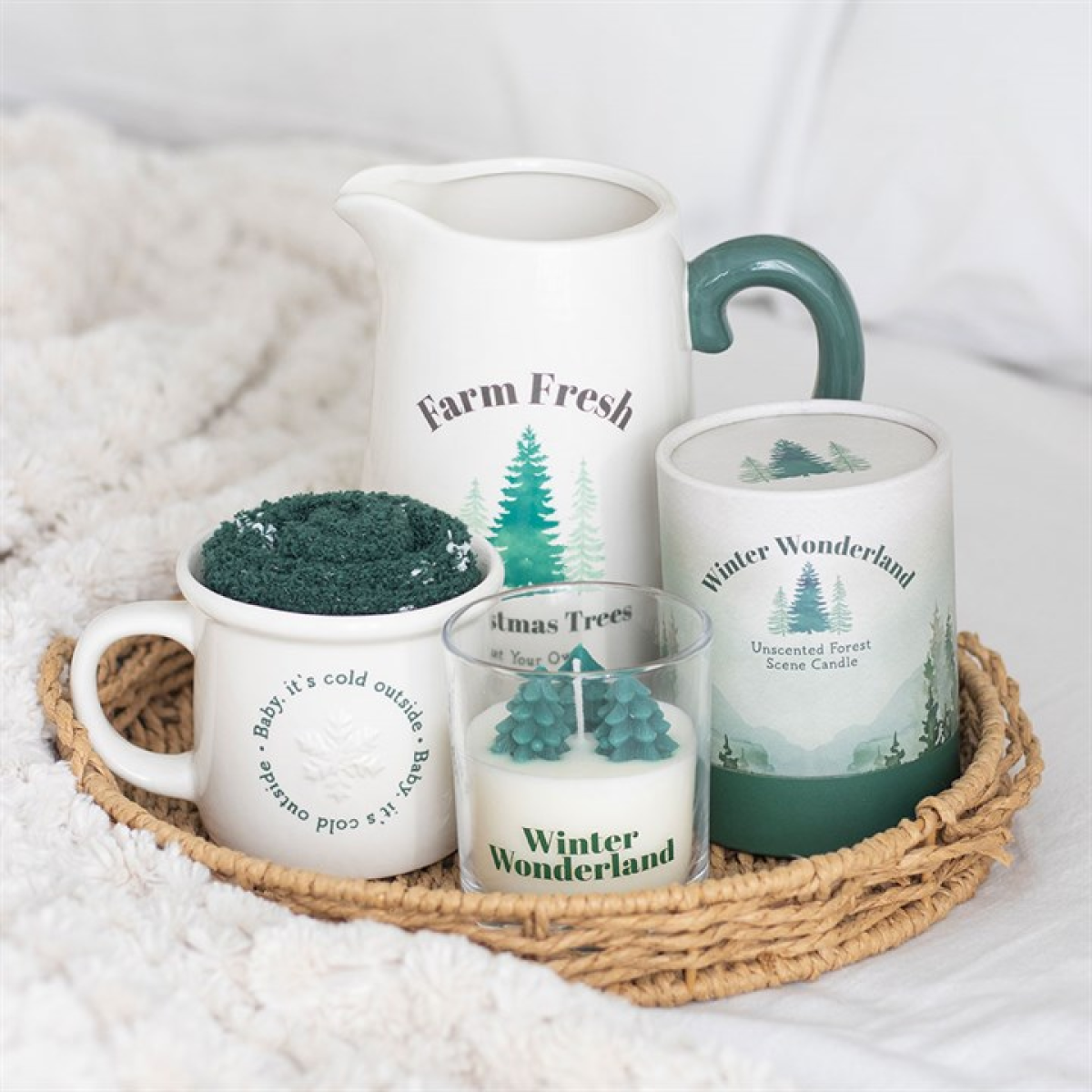 Set of 'Farm Fresh' and 'Winter Wonderland' themed mugs and candle on a woven tray.