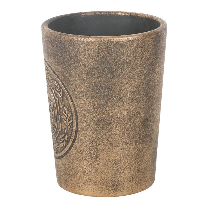 Brown textured pot with a decorative emblem on a white background