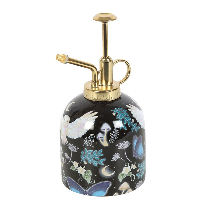 Decorative ceramic spray bottle with gold nozzle and floral design on a white background
