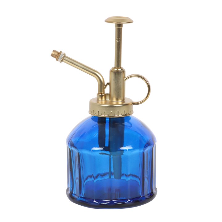 Blue glass spray bottle with brass nozzle on a white background