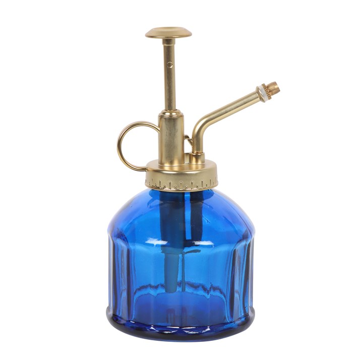 Blue glass spray bottle with brass nozzle on a white background