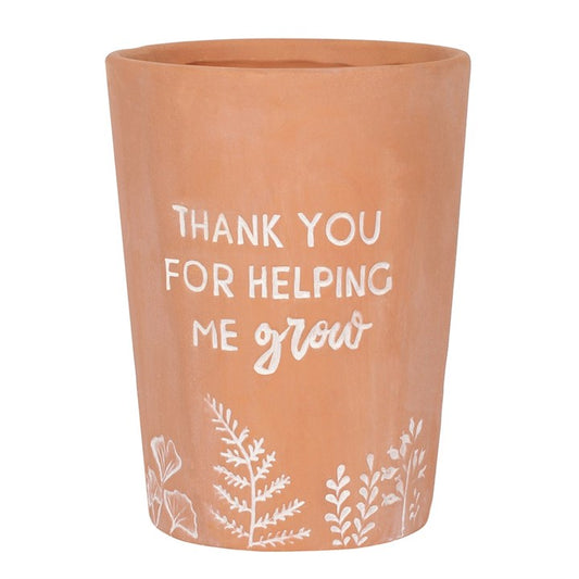 Terracotta pot with white text and floral designs on a white background