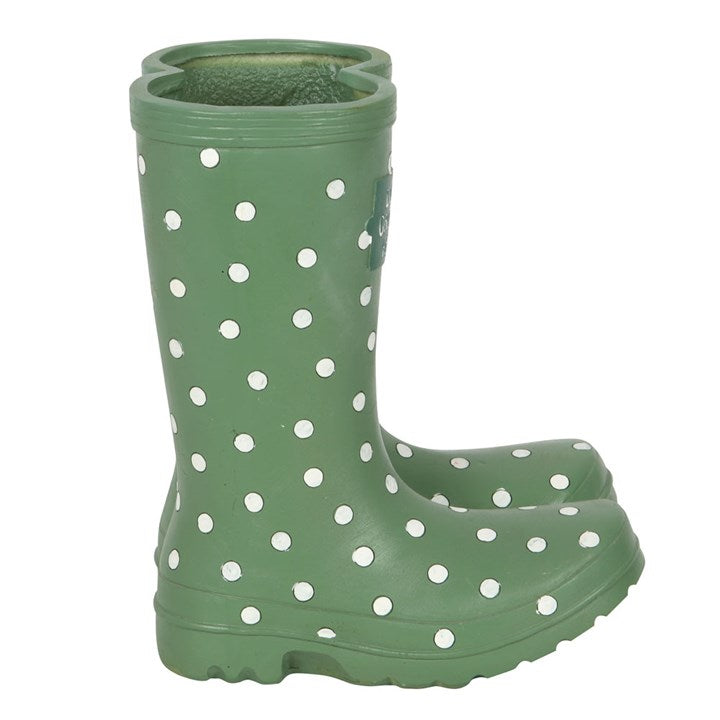Green rain boot with white polka dots on a white background