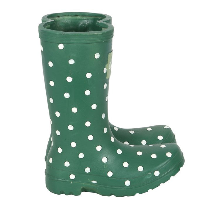 Green rain boot with white polka dots on a white background