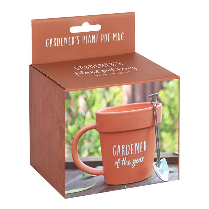 Terracotta mug with plant pot design and 'Gardener of the Year' text, displayed in packaging with a shovel.
