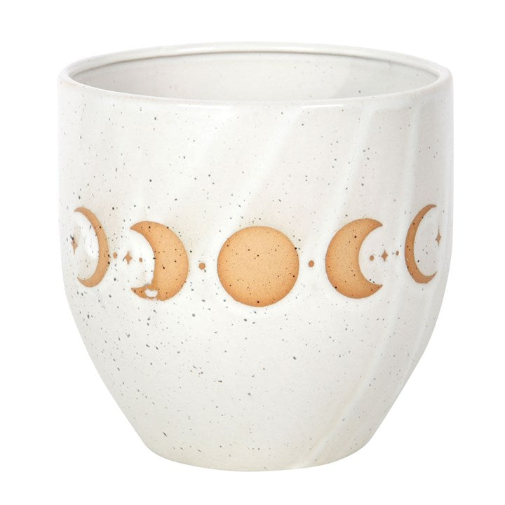 White ceramic cup with moon phase design on a white background