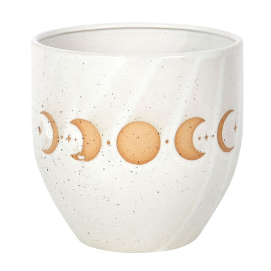 White ceramic cup with moon phase design on a white background