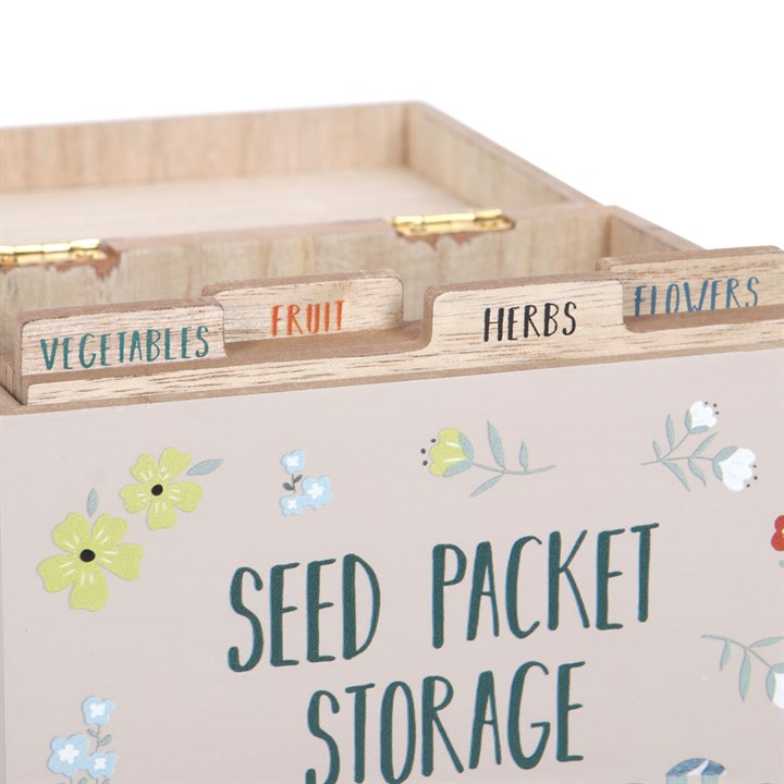Wooden seed packet storage box with compartments labeled for vegetables, fruit, herbs, and flowers.