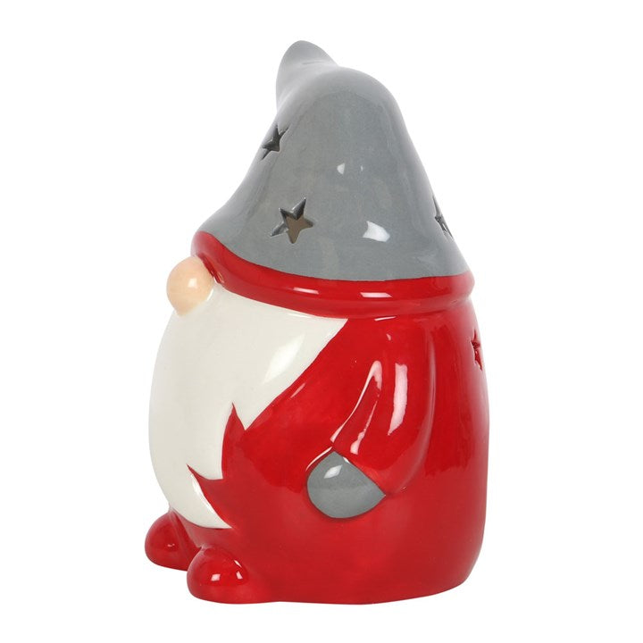 Ceramic gnome figurine with red outfit on a white background