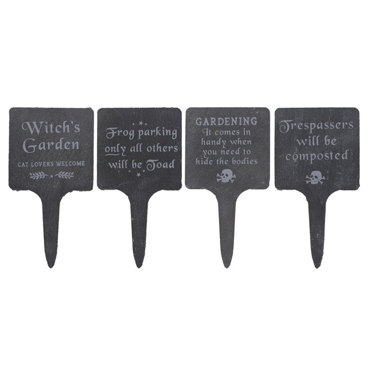 Four black garden signs with humorous sayings on a white background