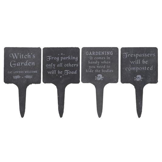 Four black garden signs with humorous sayings on a white background