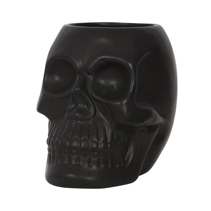 Black skull-shaped planter on a white background