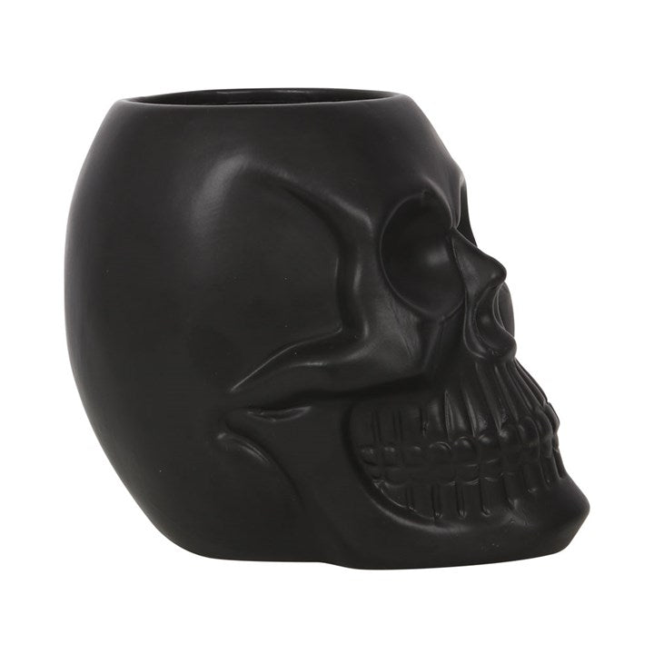 Black skull-shaped planter on a white background