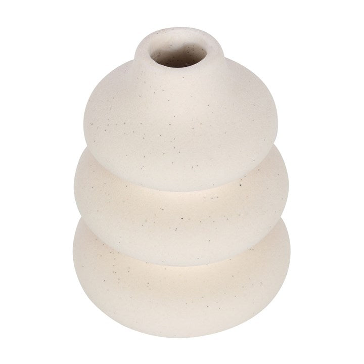 White ceramic vase with textured surface on a white background