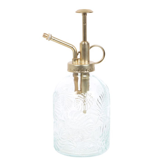 Clear glass spray bottle with brass nozzle on a white background