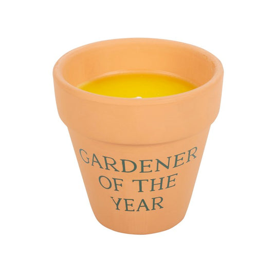 Terracotta pot with yellow candle inside and 'Gardener of the Year' text on a white background