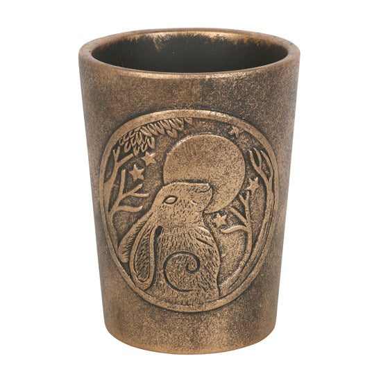 Bronze-colored plant pot with engraved design on a white background