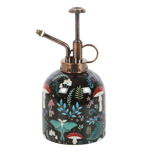 Decorative spray bottle with a forest-themed design on a white background