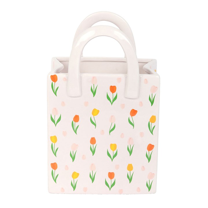Small tote bag vase with floral pattern on a white background