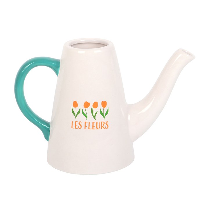 White ceramic watering can with teal handle and 'LES FLEURS' text and flower design on a white background