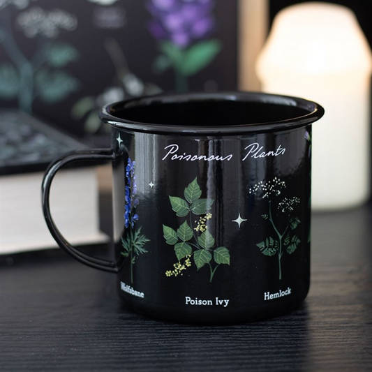 Black mug with plant illustrations and text on a desk