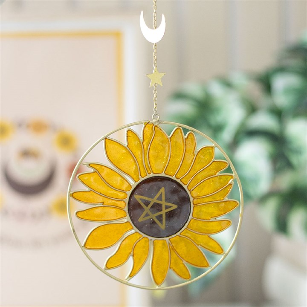 Sunflower-shaped decorative hanging with a star in the center, featuring a moon and star design on a blurred background.