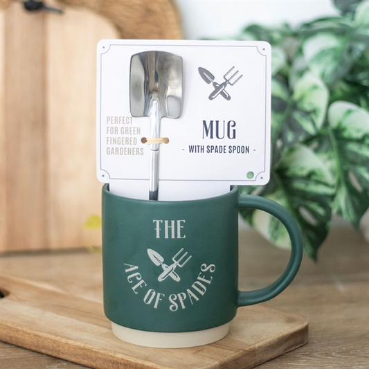 Green mug with spade spoon and packaging on a wooden surface