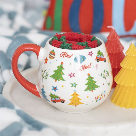 Decorative Christmas-themed mug with colorful designs on a festive background.